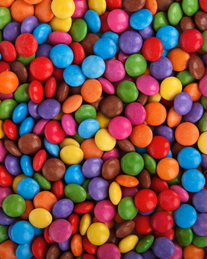 An array of colourful small chocolate buttons