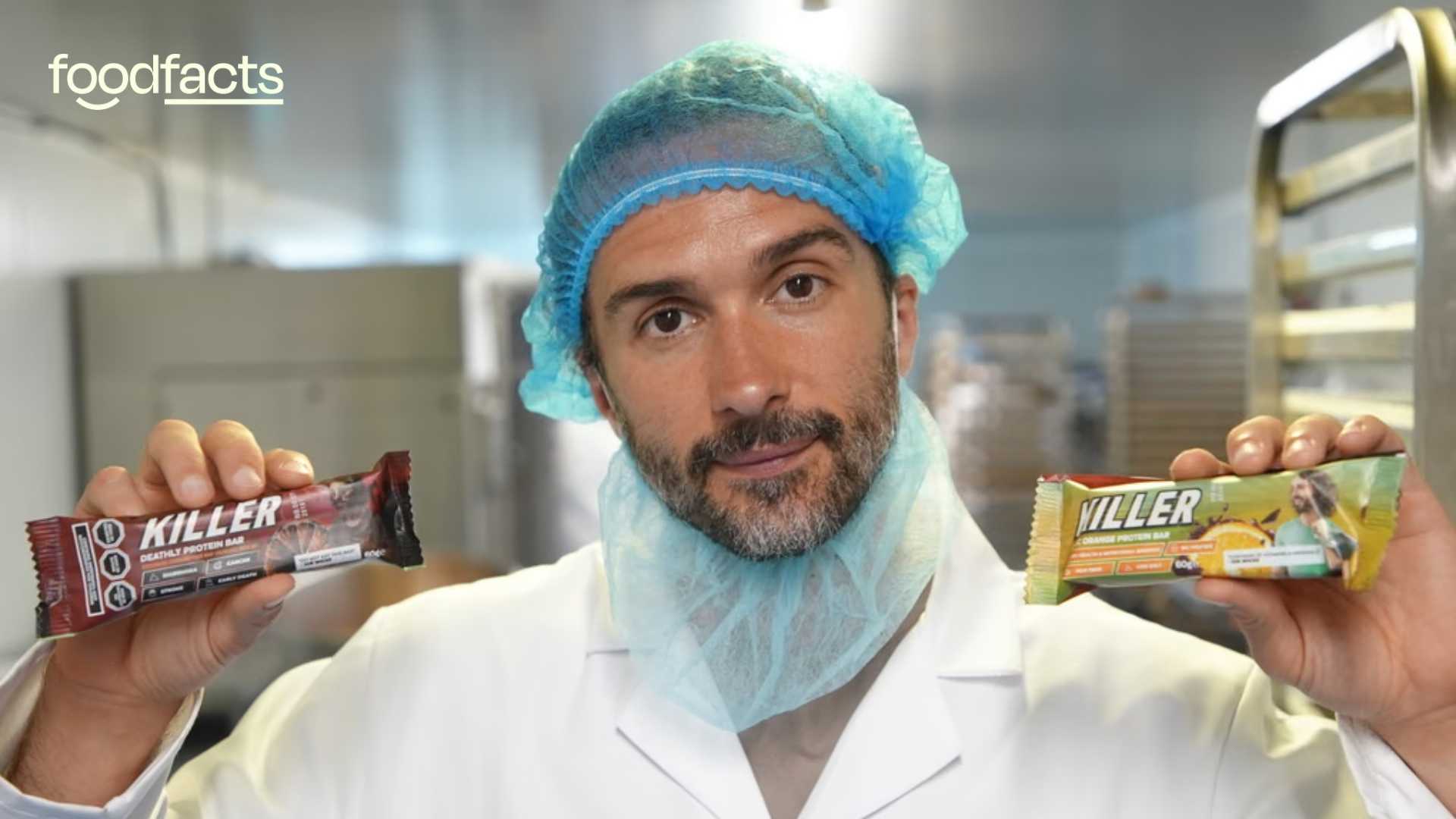 Joe Wicks holds two of his killer bars, one in each hand