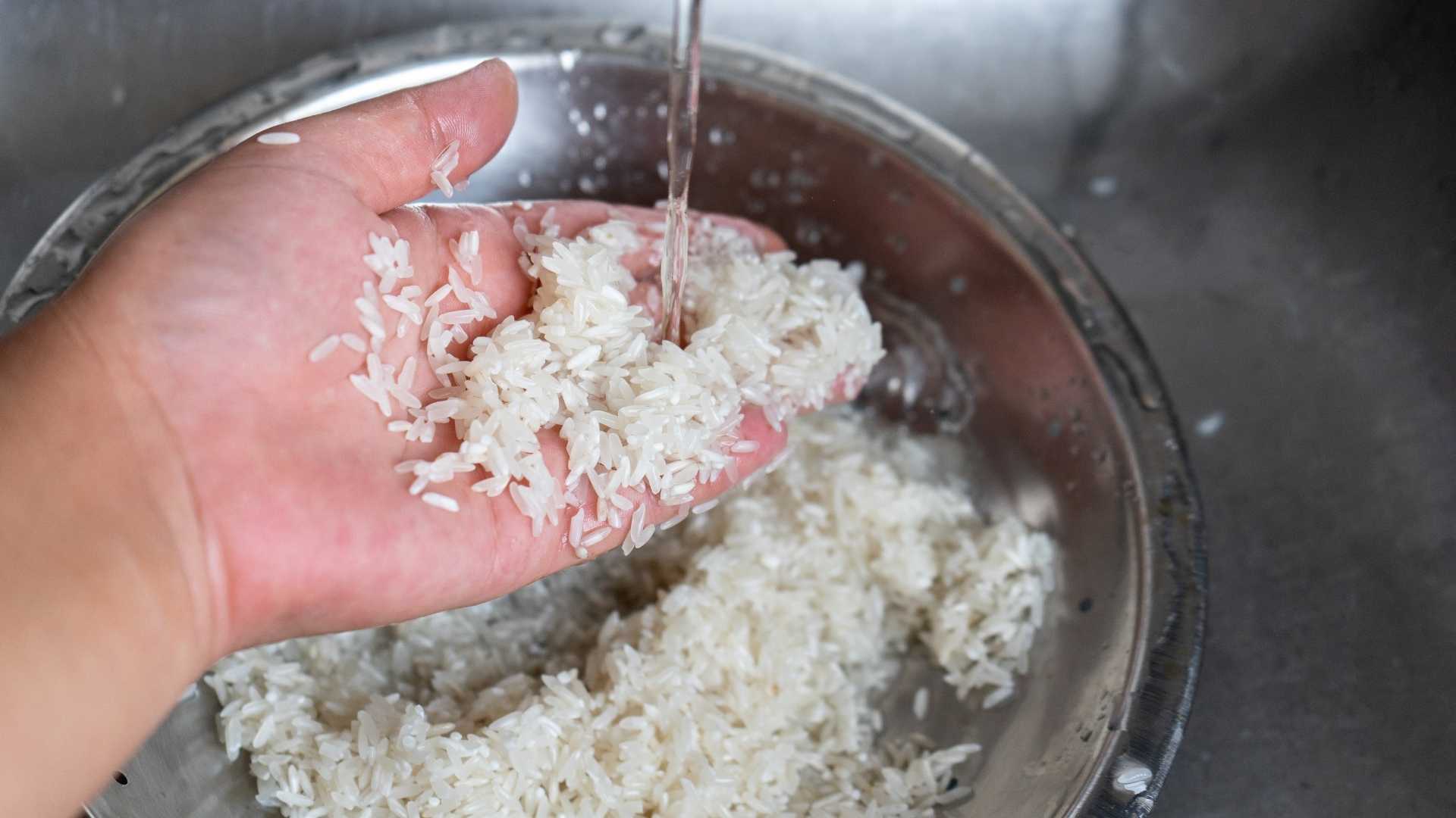 A person washes white rice