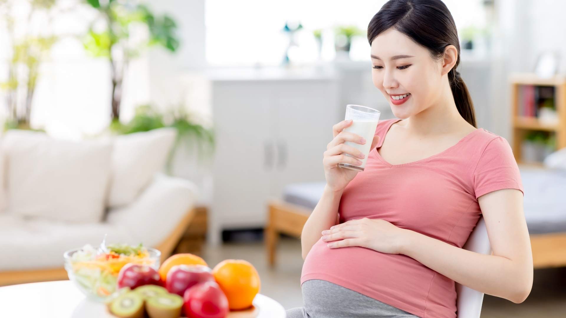 A pregnant woman drinks a glass of milk