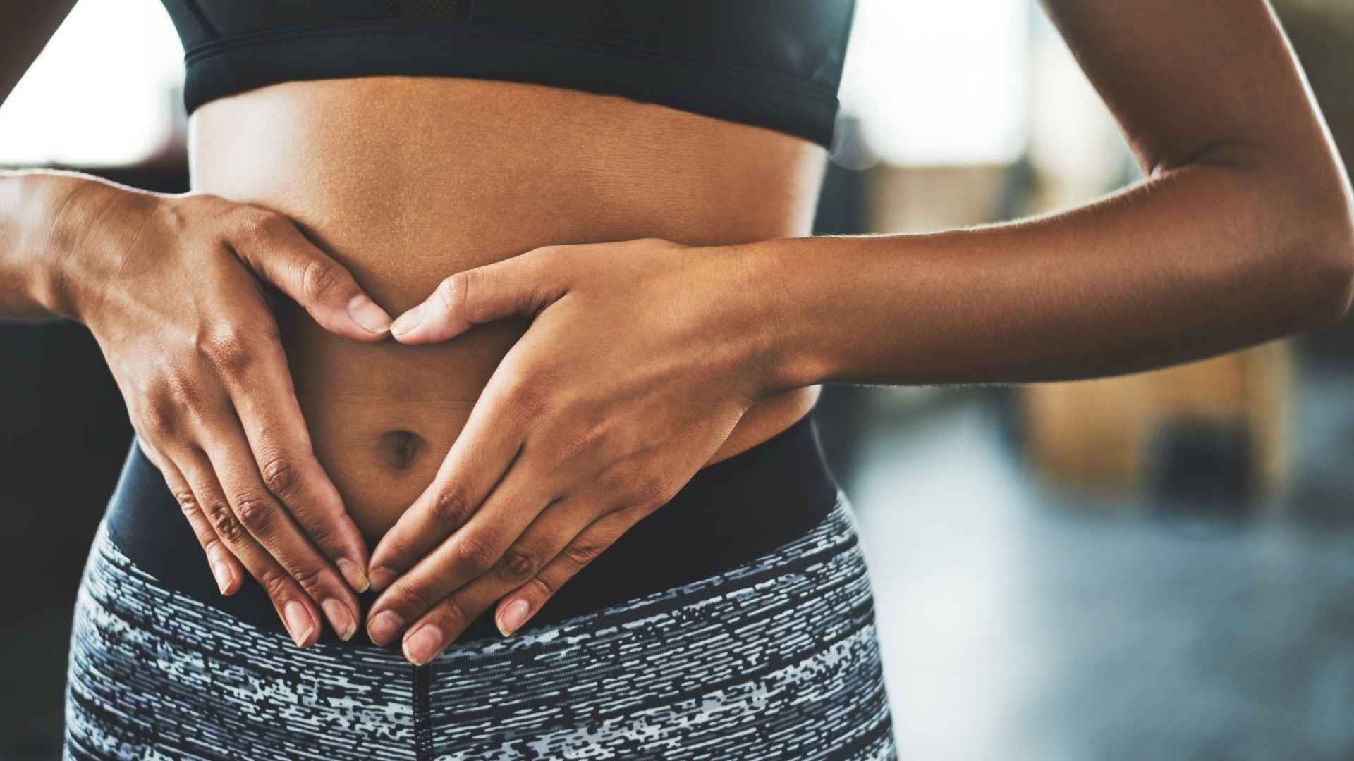 A woman holds her stomach