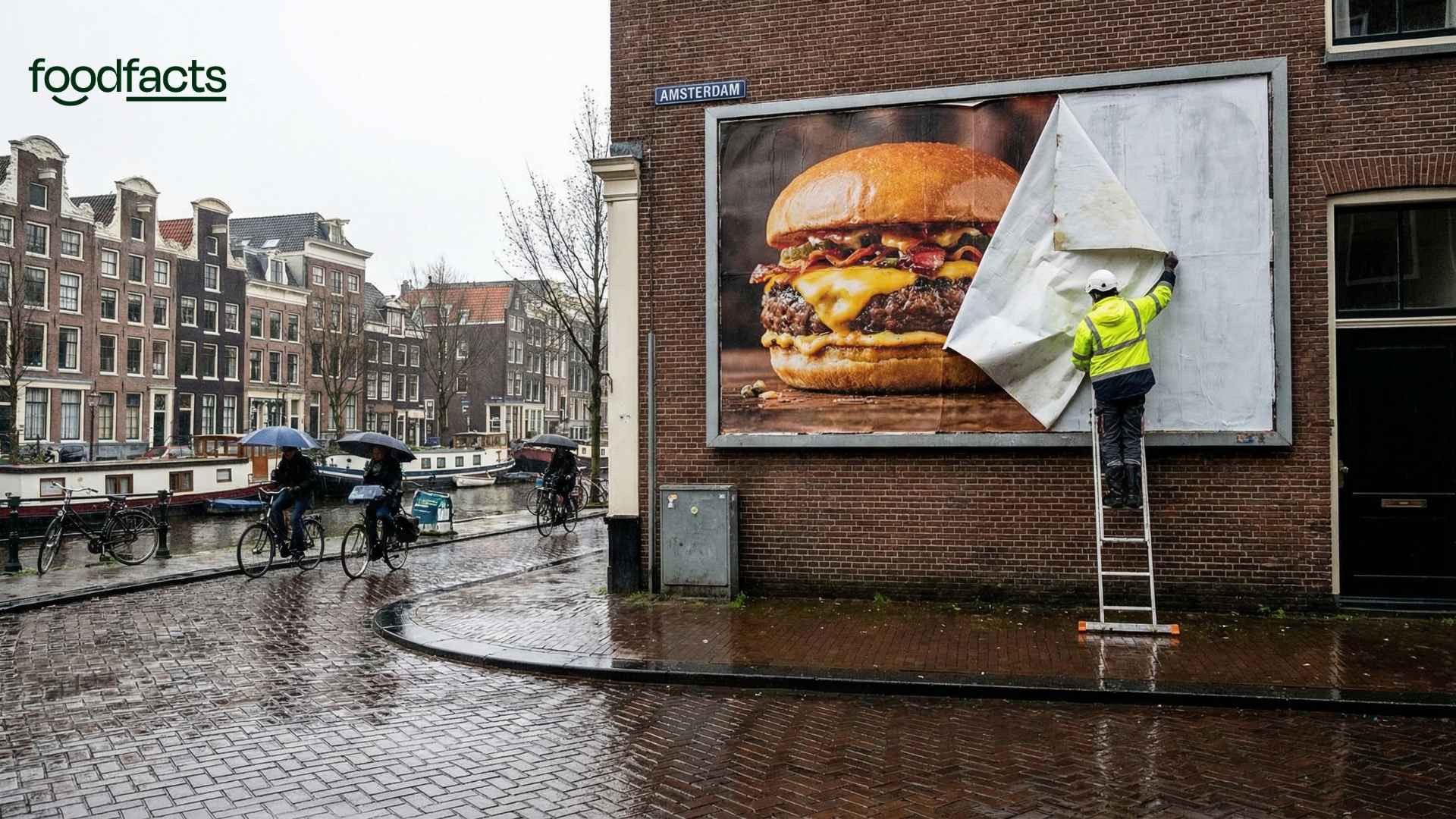 A person removes a meat advert from a street in Amsterdam