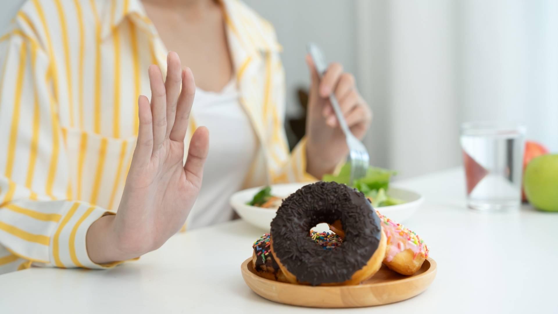 A person refuses a donut