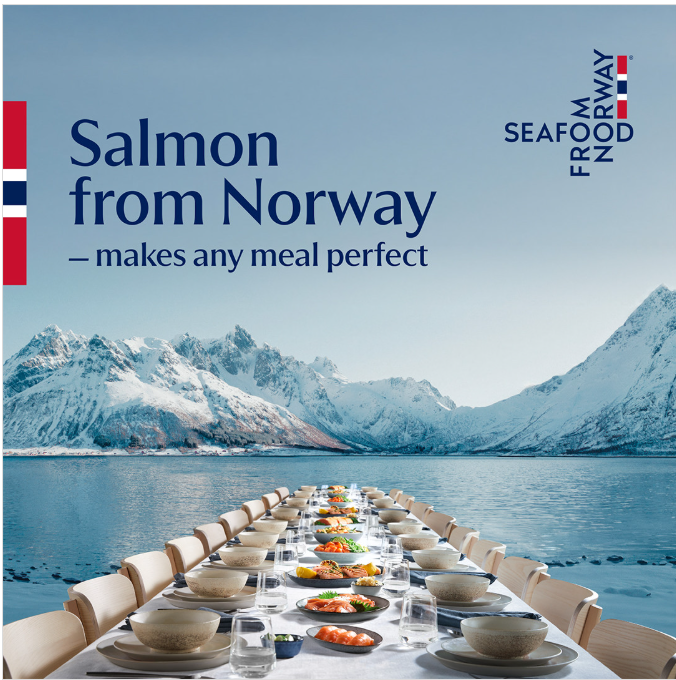 A dining table with plates of salmon sits over a Norwegian fjord