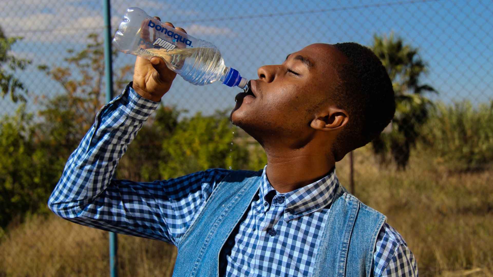 A person drinks bottled water