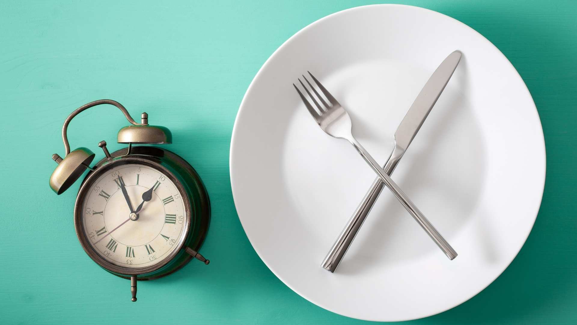An empty plate next to a clock