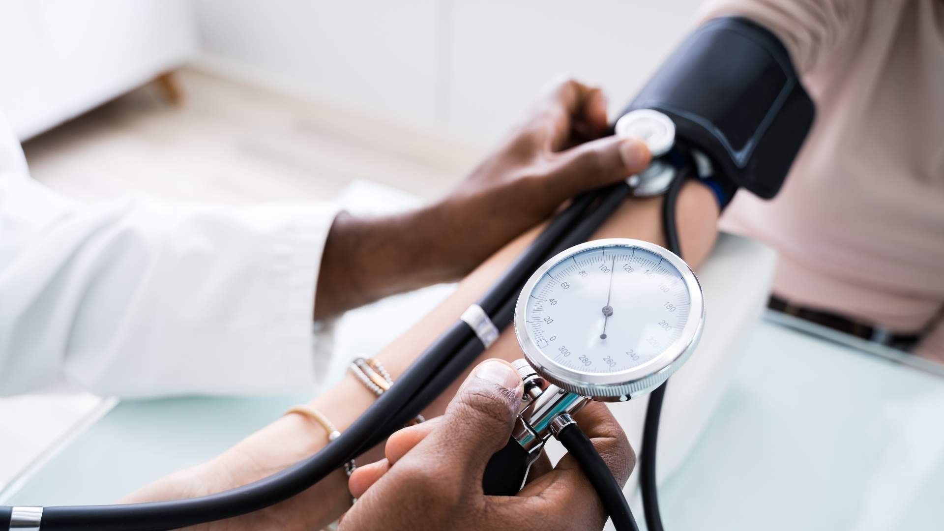 A doctor measures someone's blood pressure
