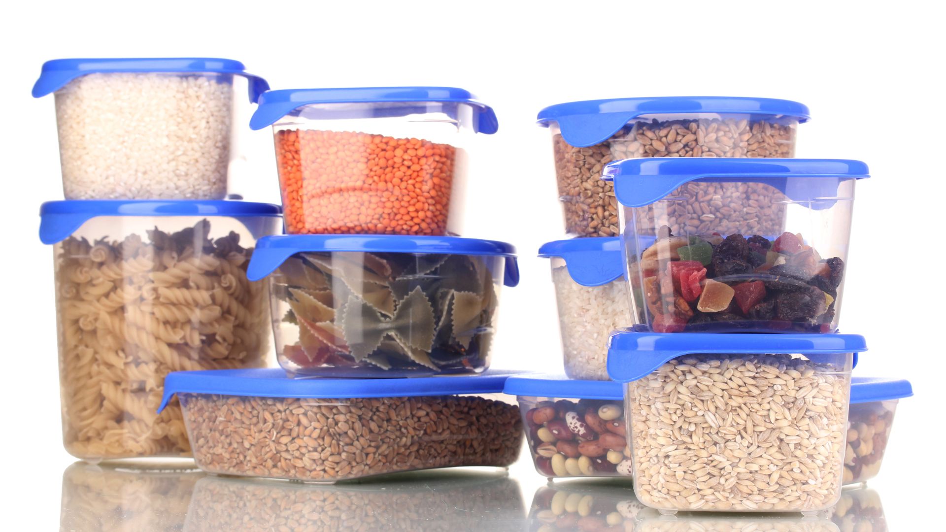 Multiple plastic tupperwares containing different dried foods.