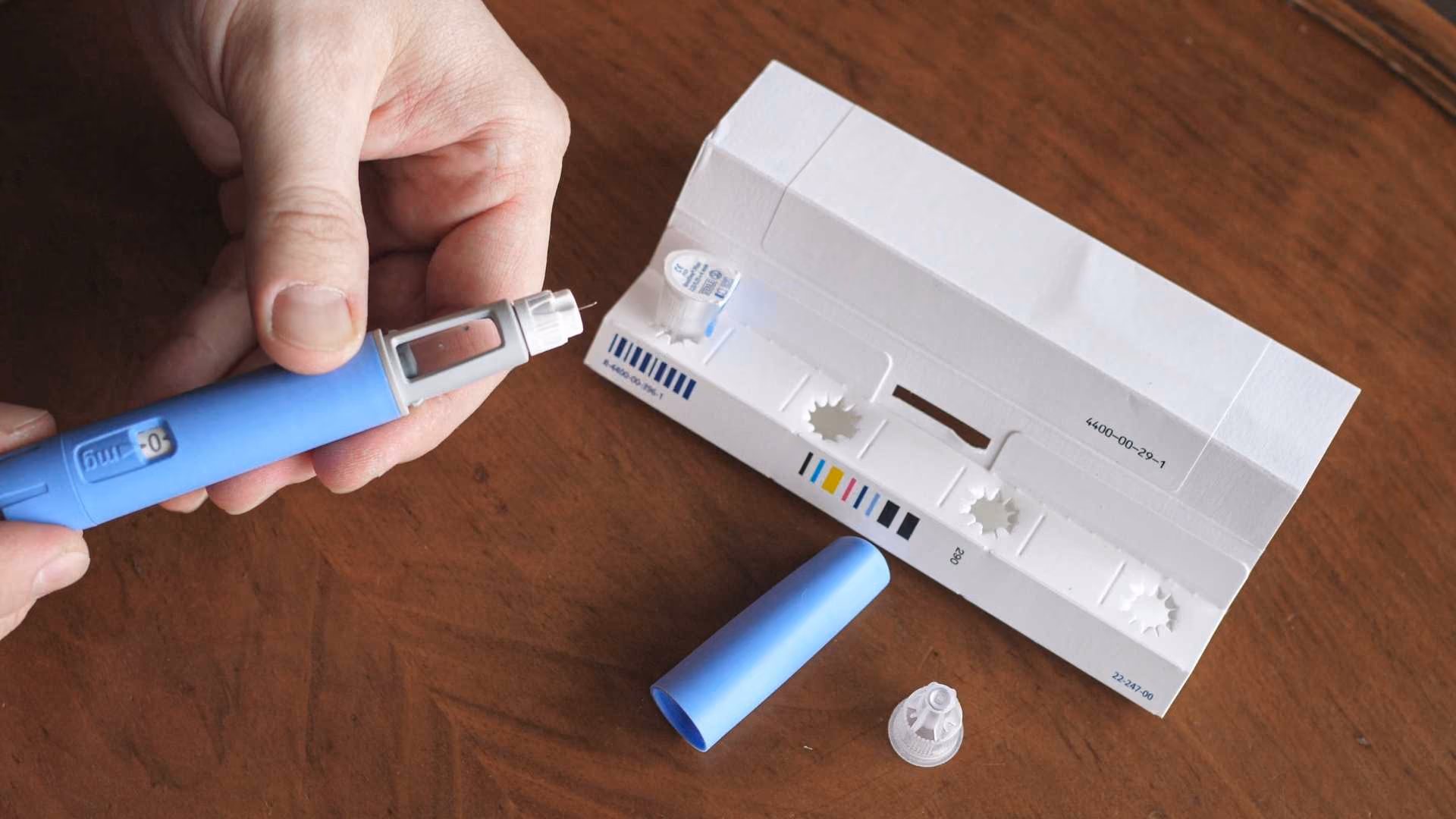 A person holds a GLP-1 injector