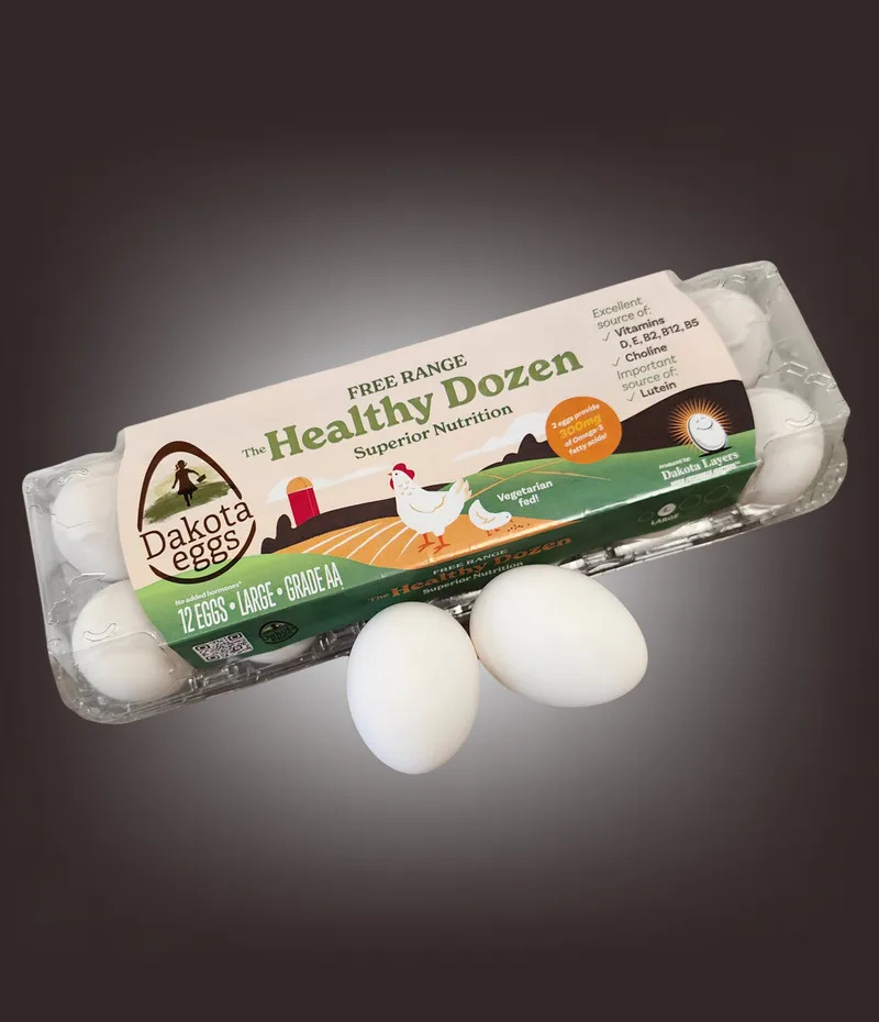 A pack of free range eggs shows chickens roaming freely in fields