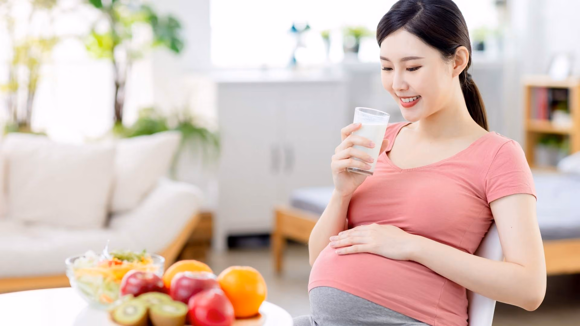 A pregnant woman drinks a glass of milk