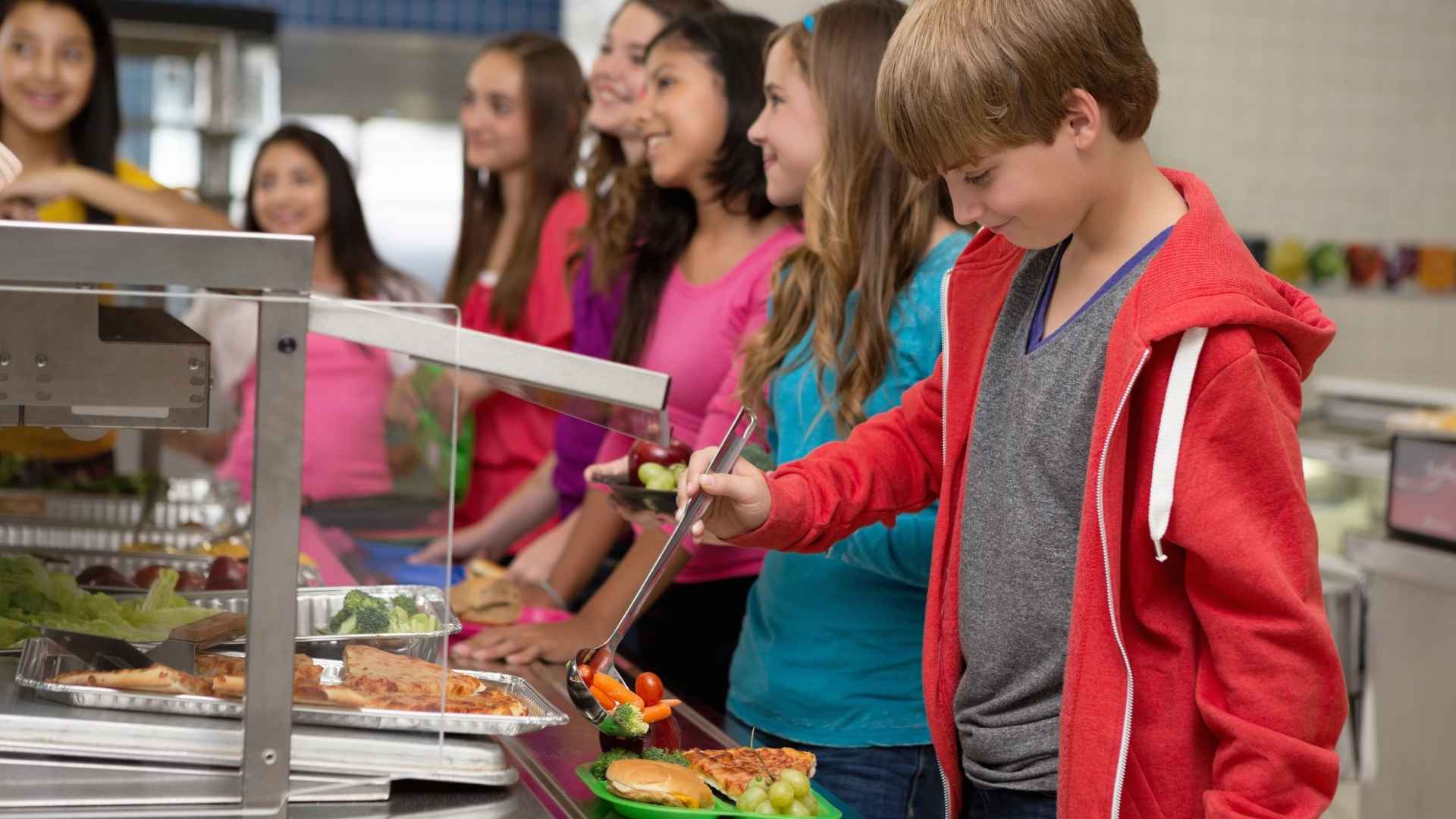 A child takes food from the school cafetaria
