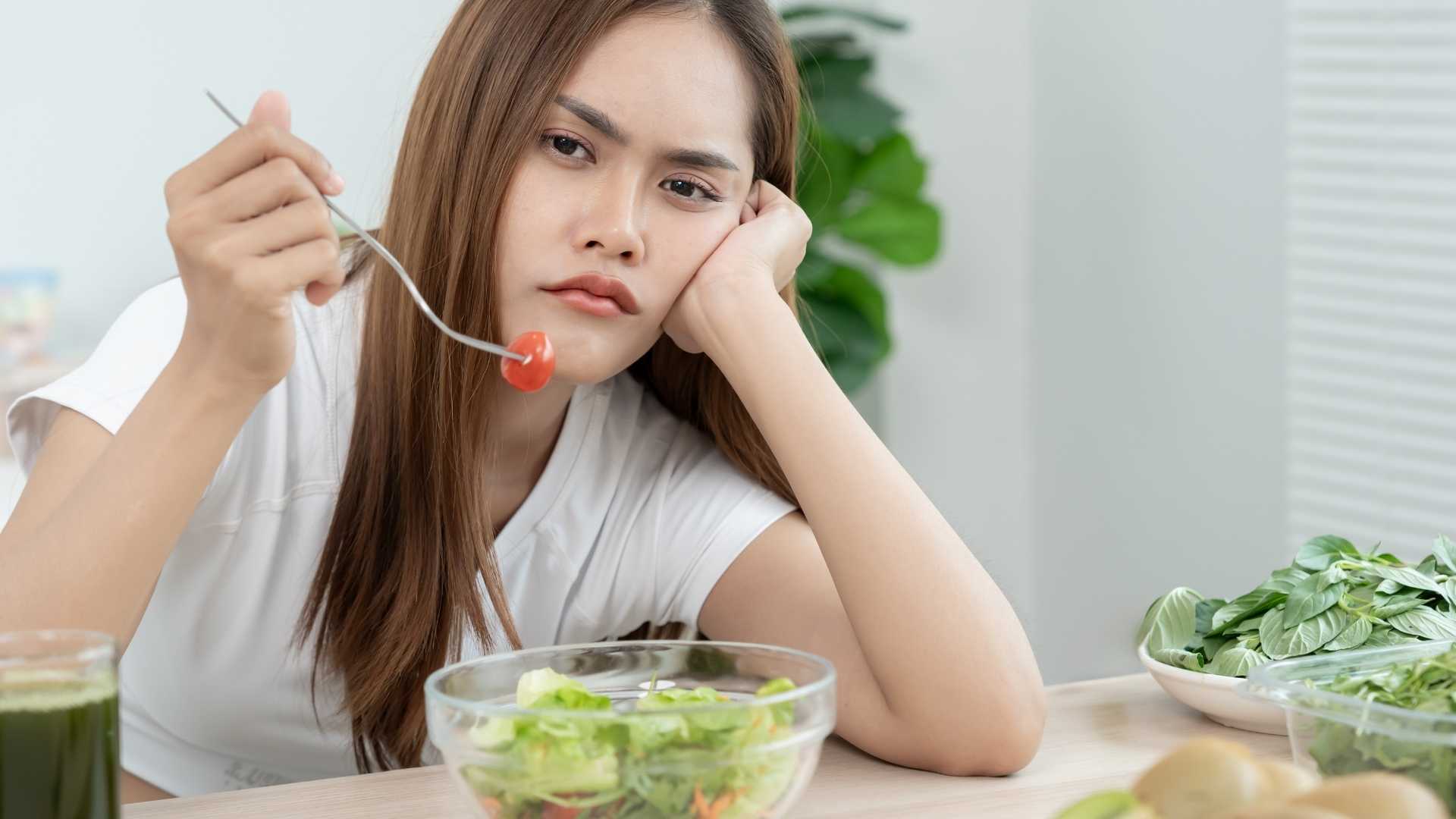 A woman eats a salad