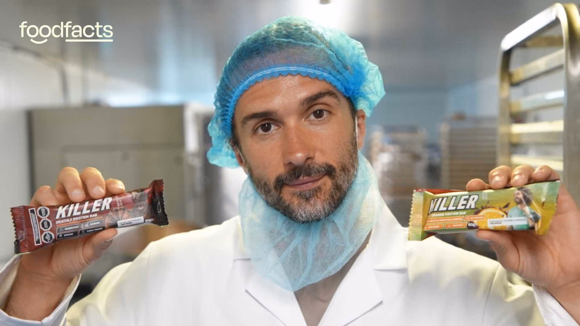 Joe Wicks holds two of his killer bars, one in each hand