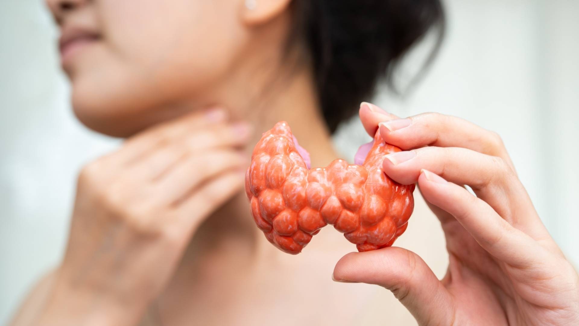 A person suffers with a swollen thyroid gland