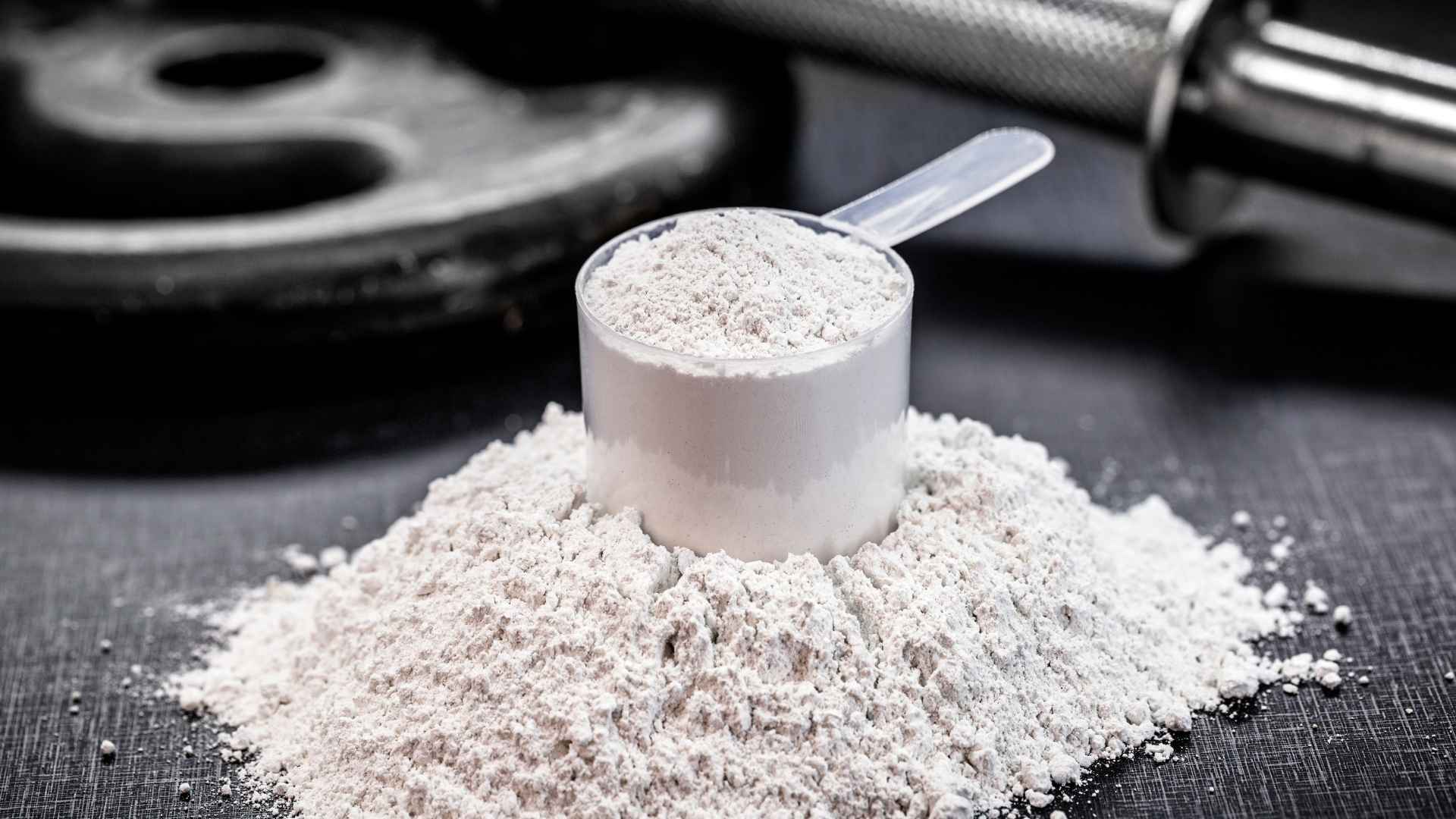 A pile and scoop of creatine powder