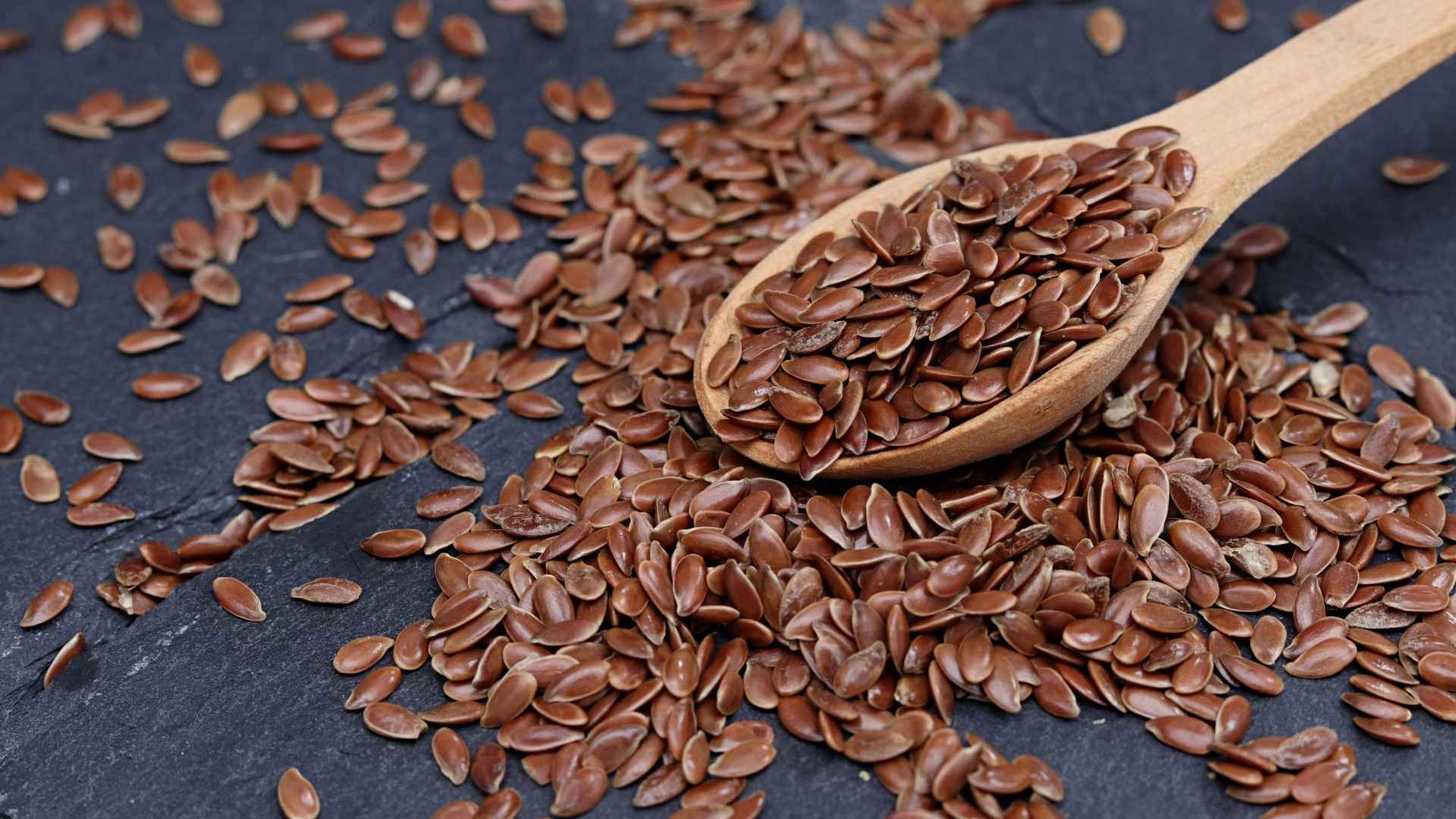 A person takes a scoop of flaxseeds