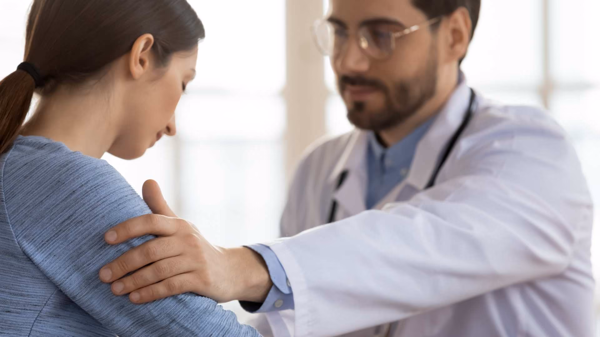 A doctor comforts their patient