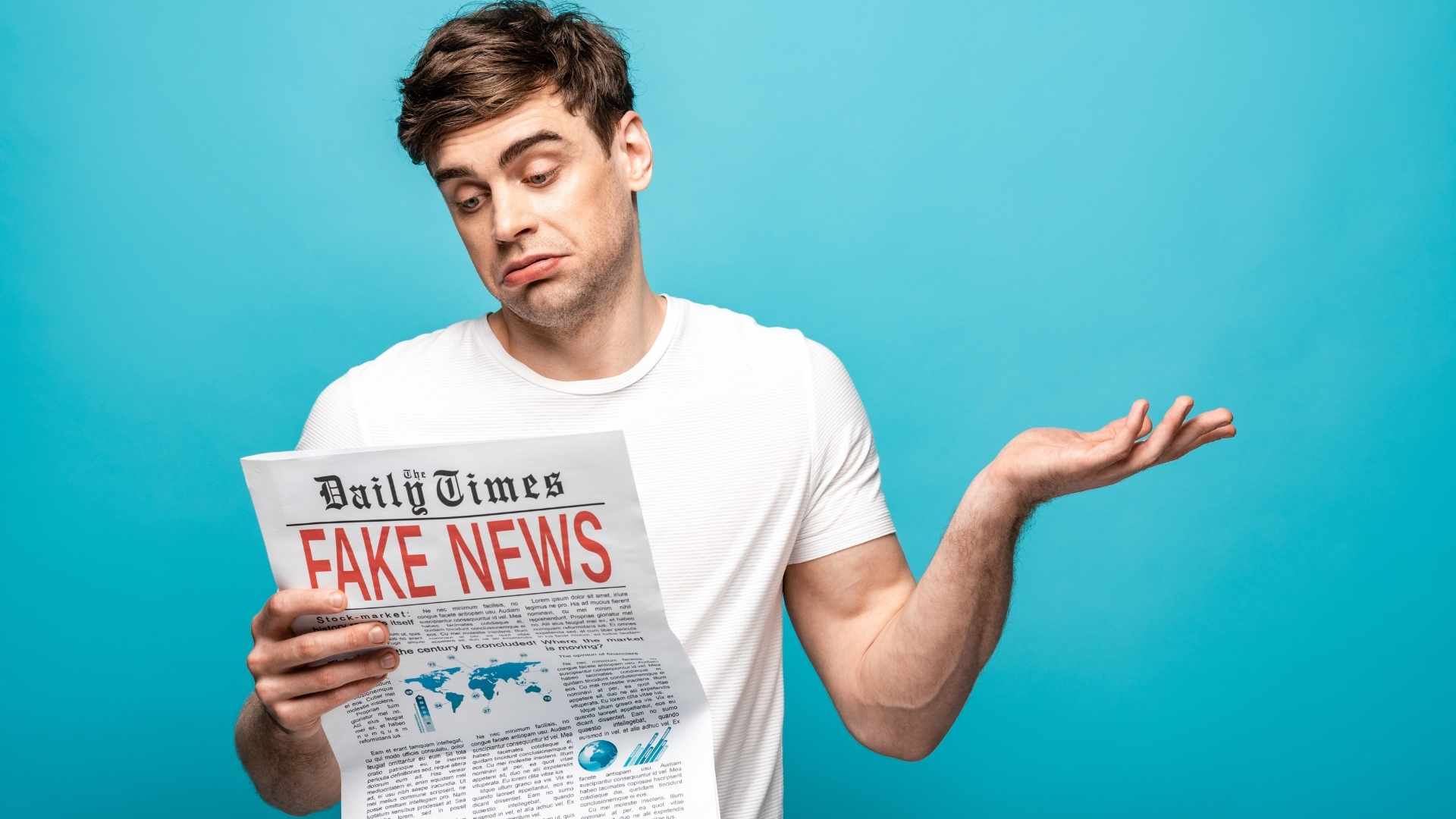 A person reads a newspaper full of misinformation