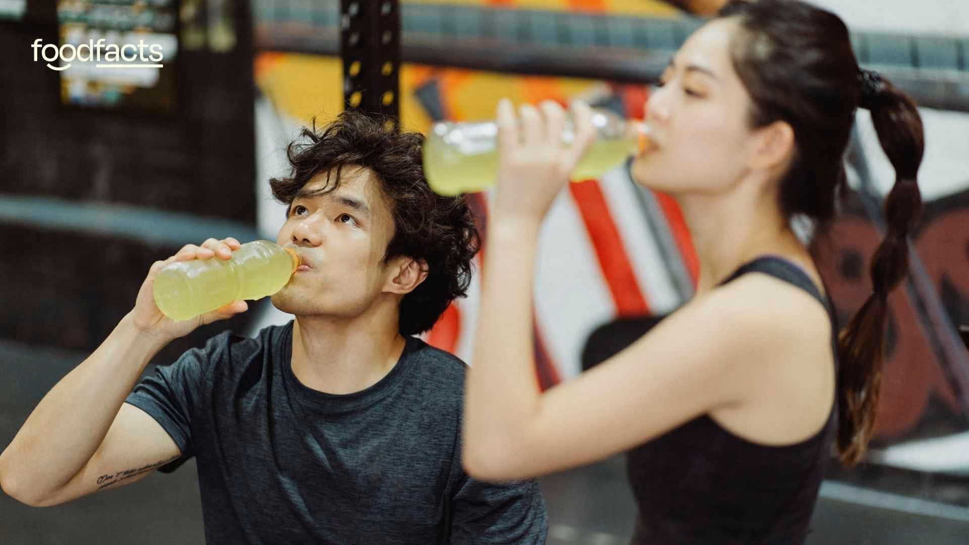 A group of athletes drink electrolyte drinks