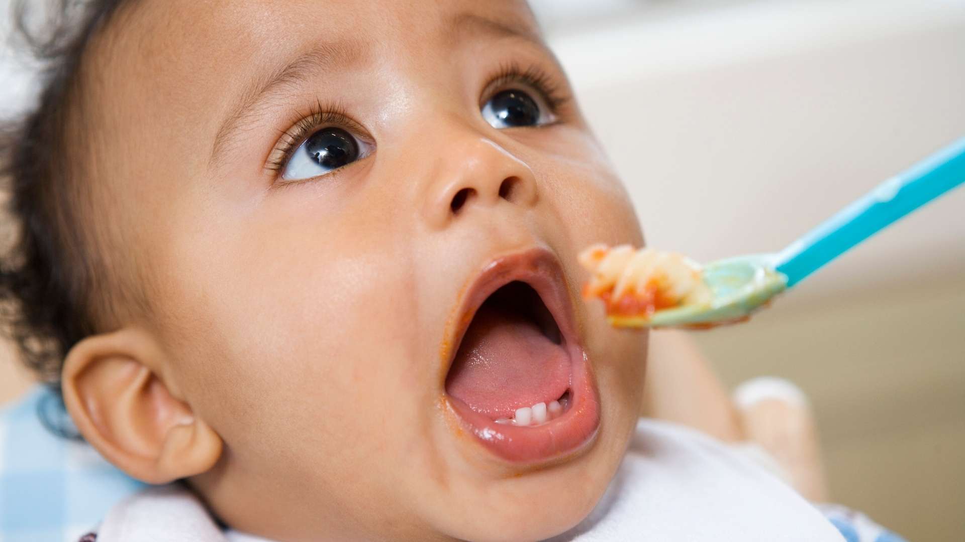 A baby eats food