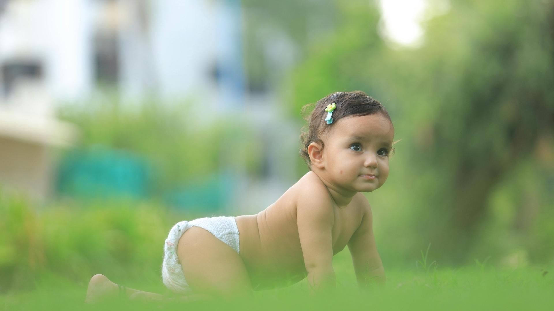 A baby crawls on the ground