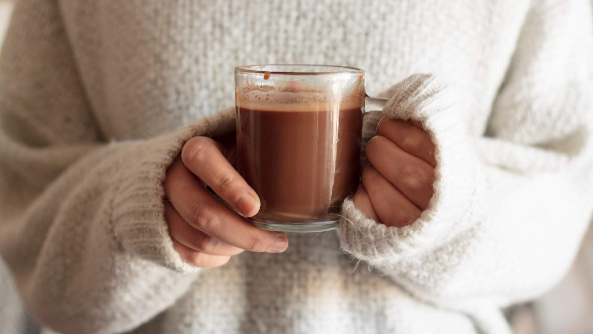 Someone drinks a cup of hot chocolate