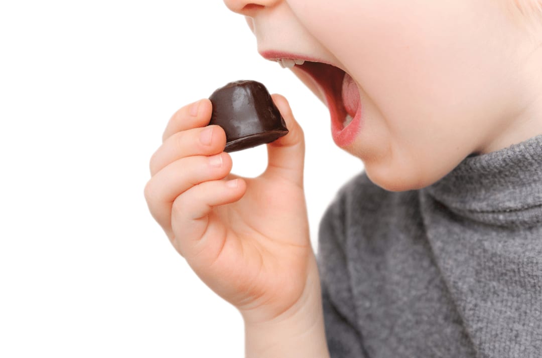 A child eating a chocolate candy