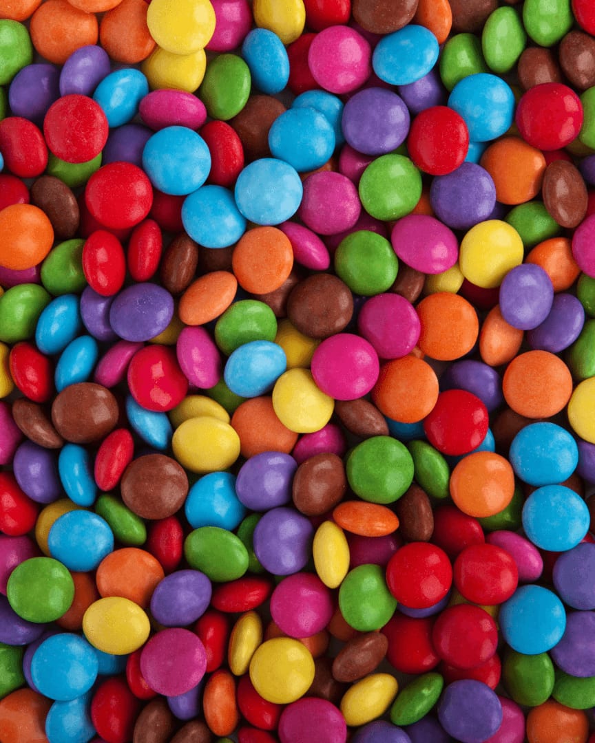 An array of colourful small chocolate buttons