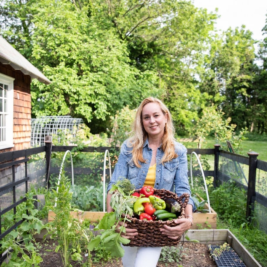A picture of Toni Farmer in her garden, Toni is a farmer, a policy advocate, and in industrial-scale food manufacturing.