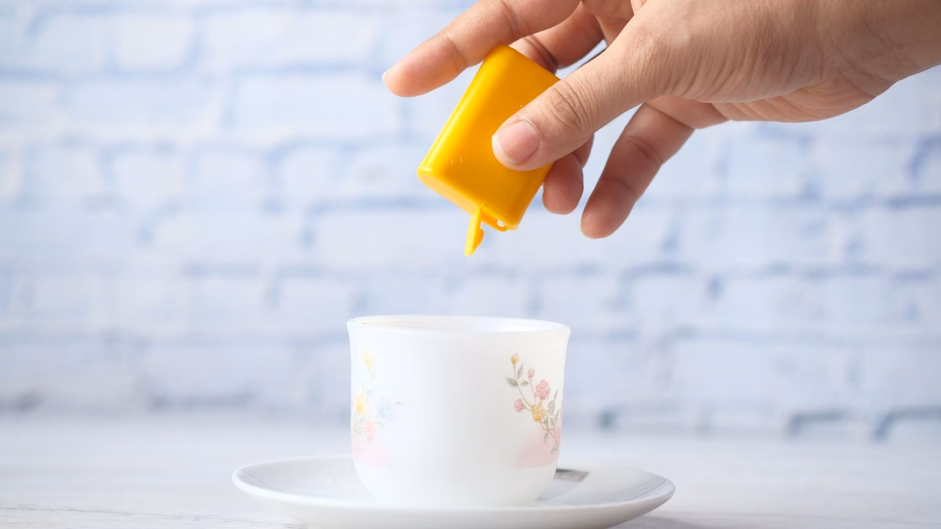 Artificial sweetener being used in a coffee