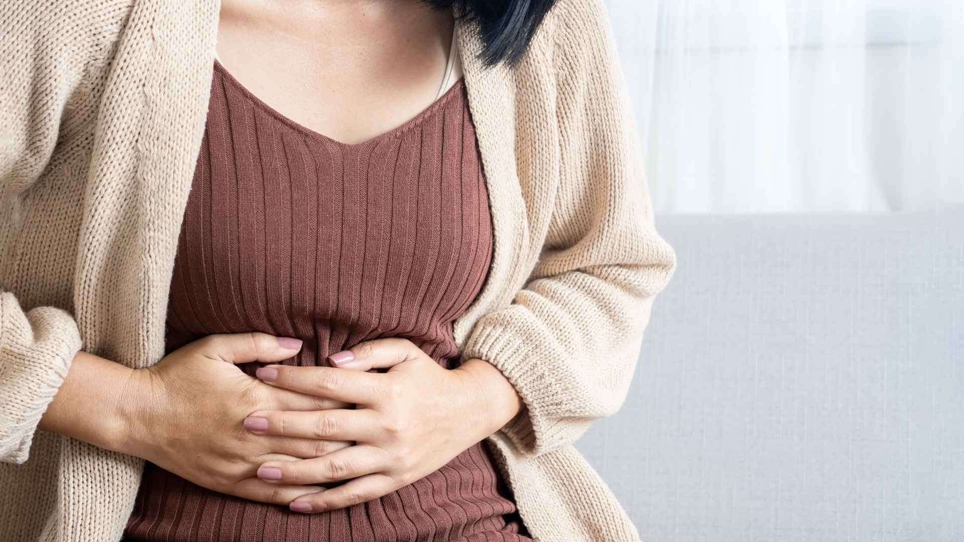 A woman is in pain from a bloated stomach
