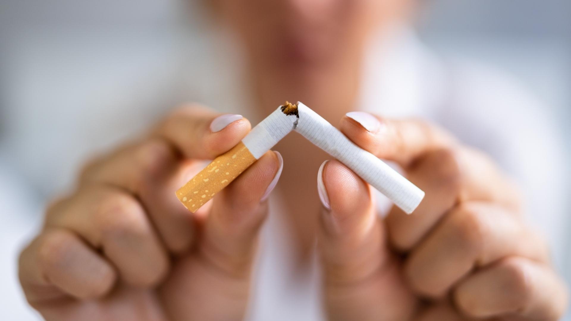 A person breaks a cigarette