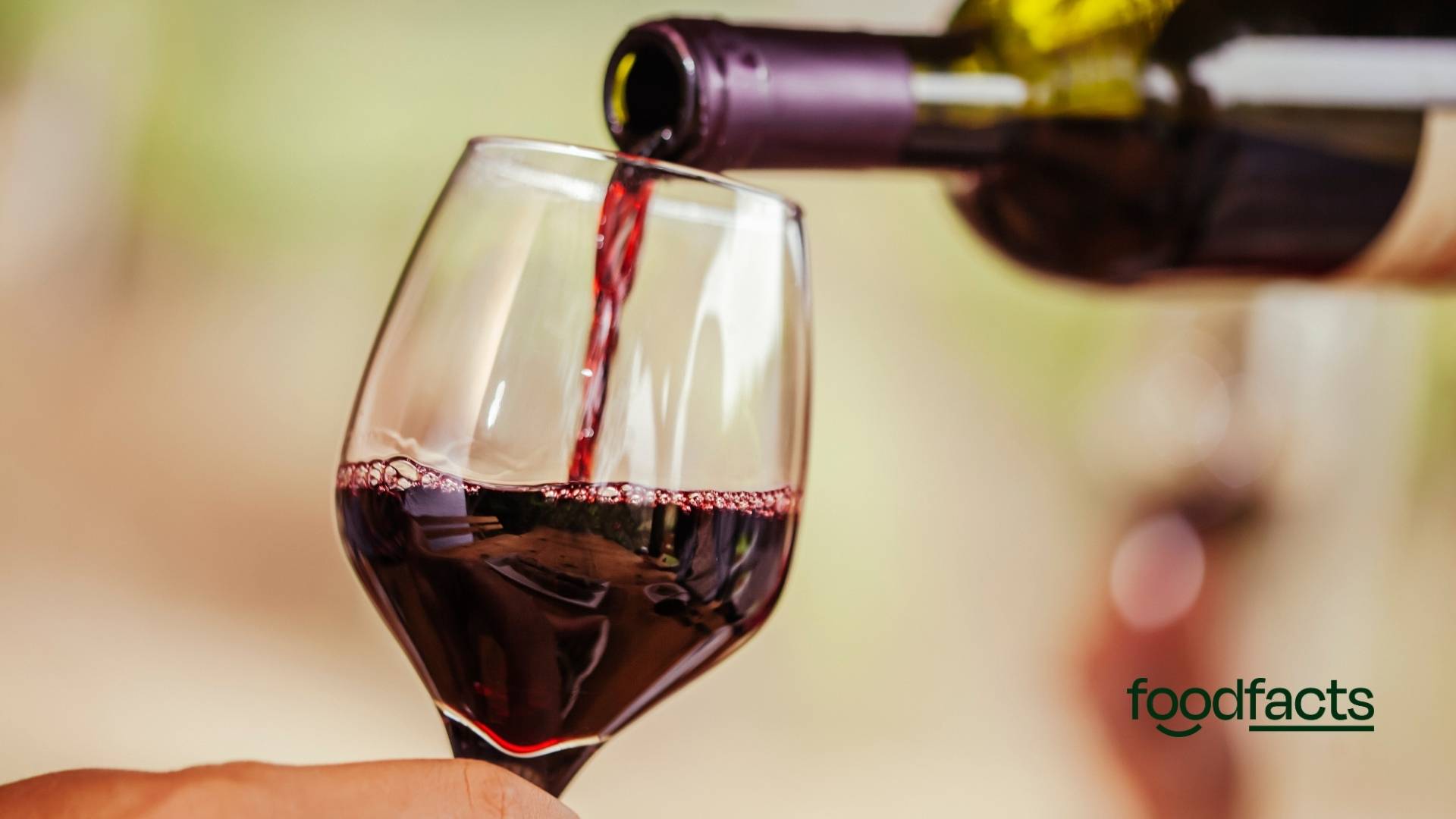 two glasses of red wine with grapes