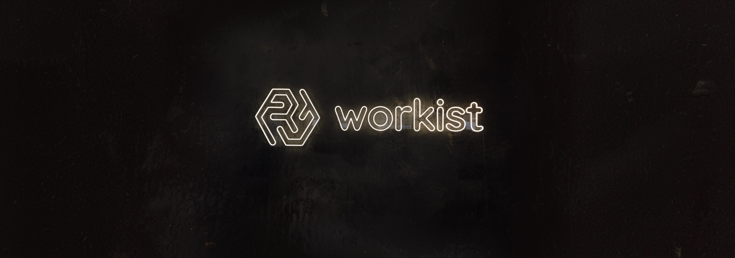 A glowing Sign of the Workist Logo