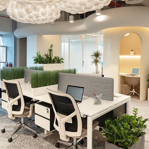 Shared coworking space with flexible desks and greenery at Cloud Spaces Roshn Front