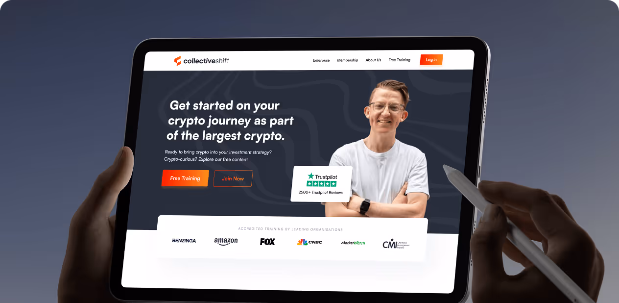 Tablet showing crypto training site with a man crossed arms and Trustpilot rating, held in hand using a stylus by Wavespace.