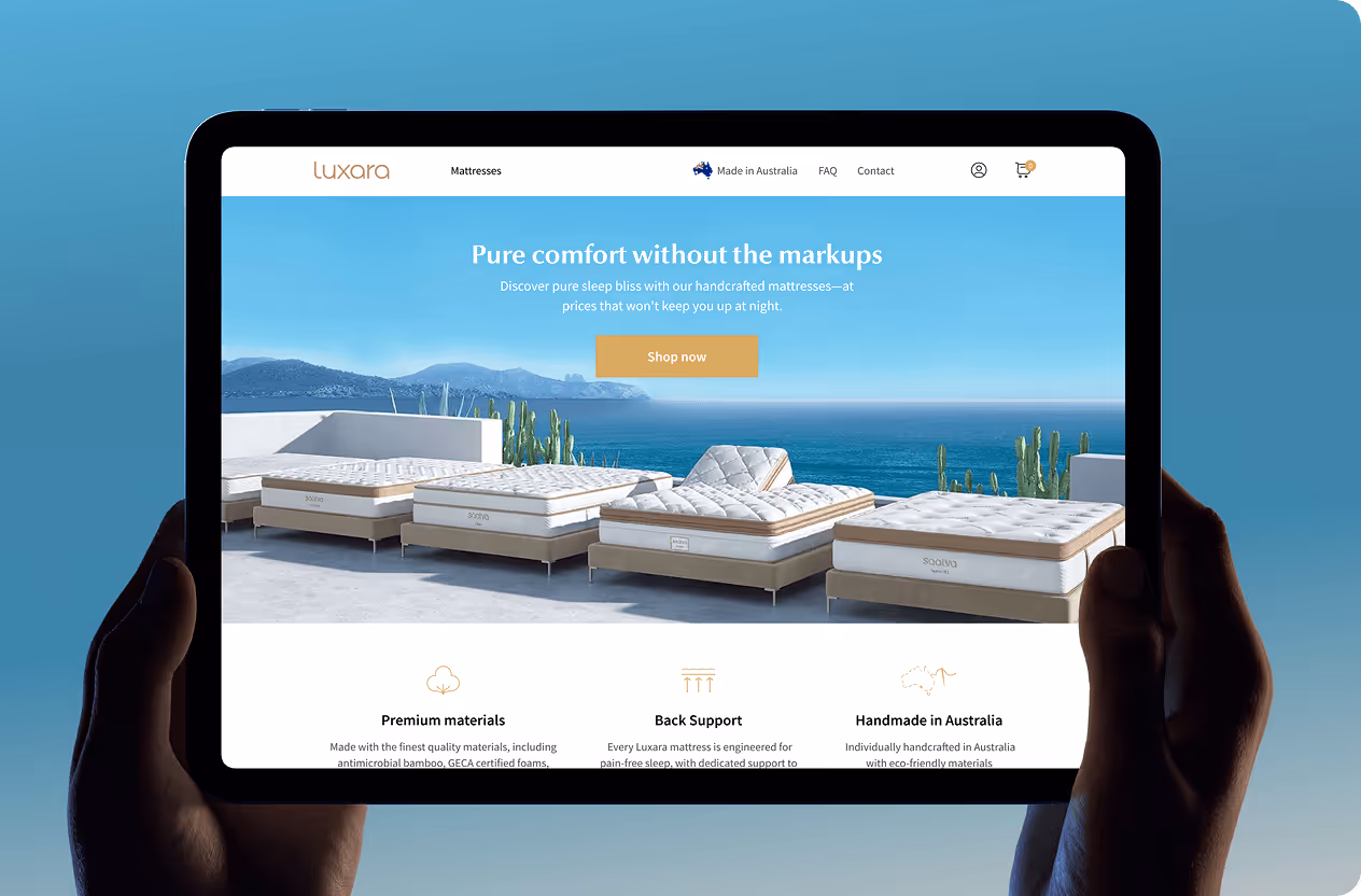Tablet showing Luxara mattress website with outdoor mattress models against ocean backdrop by Wavespace.