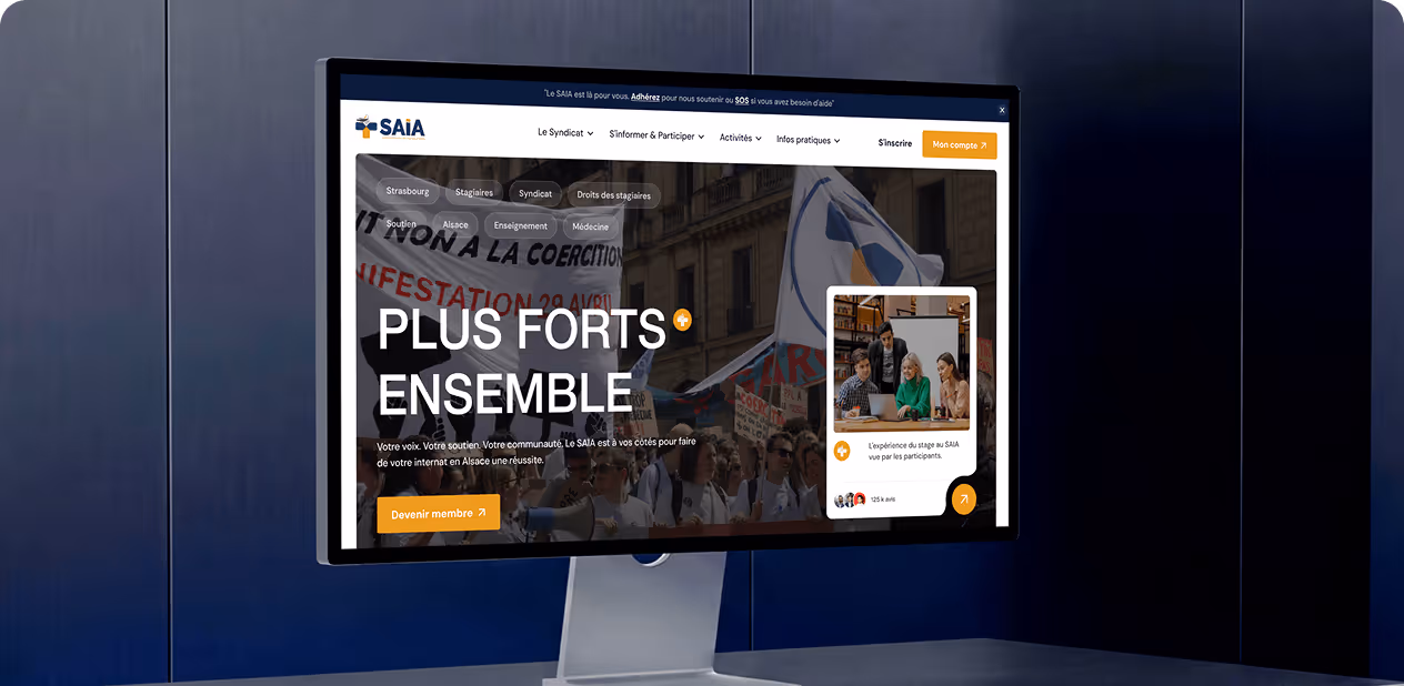 Computer showing SAIA website homepage by Wavespace with French text and a group photo of people collaborating.