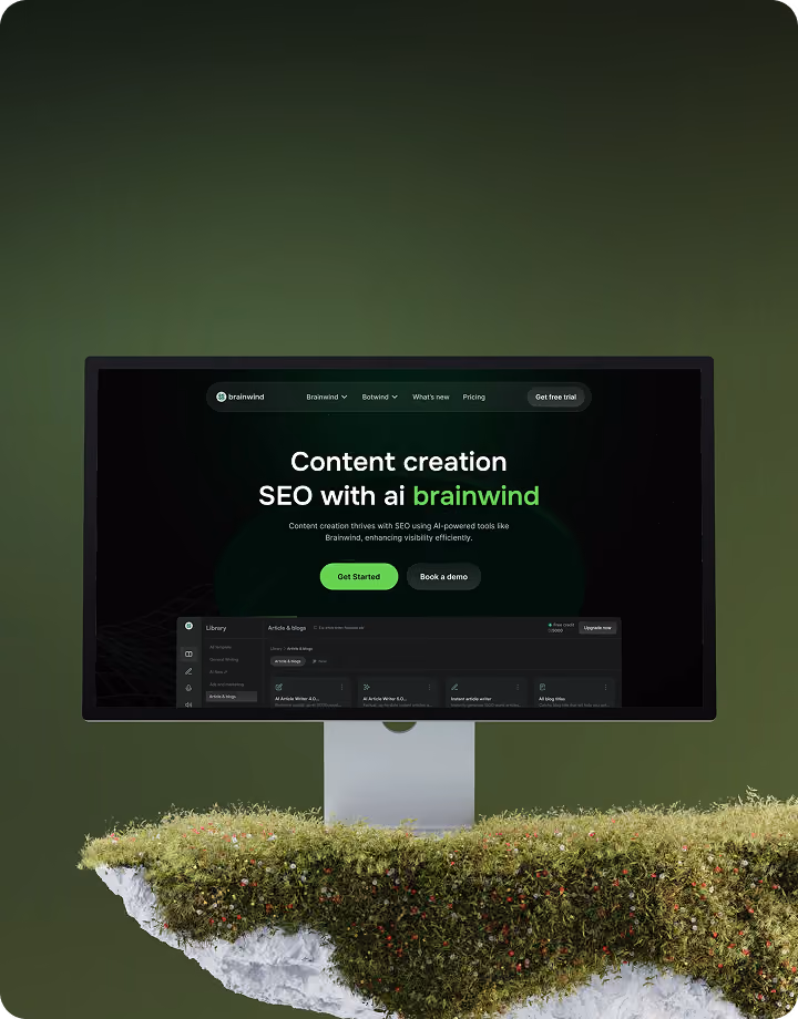 Computer monitor showing Brainwind AI content creation and SEO tool interface on a floating mossy rock.