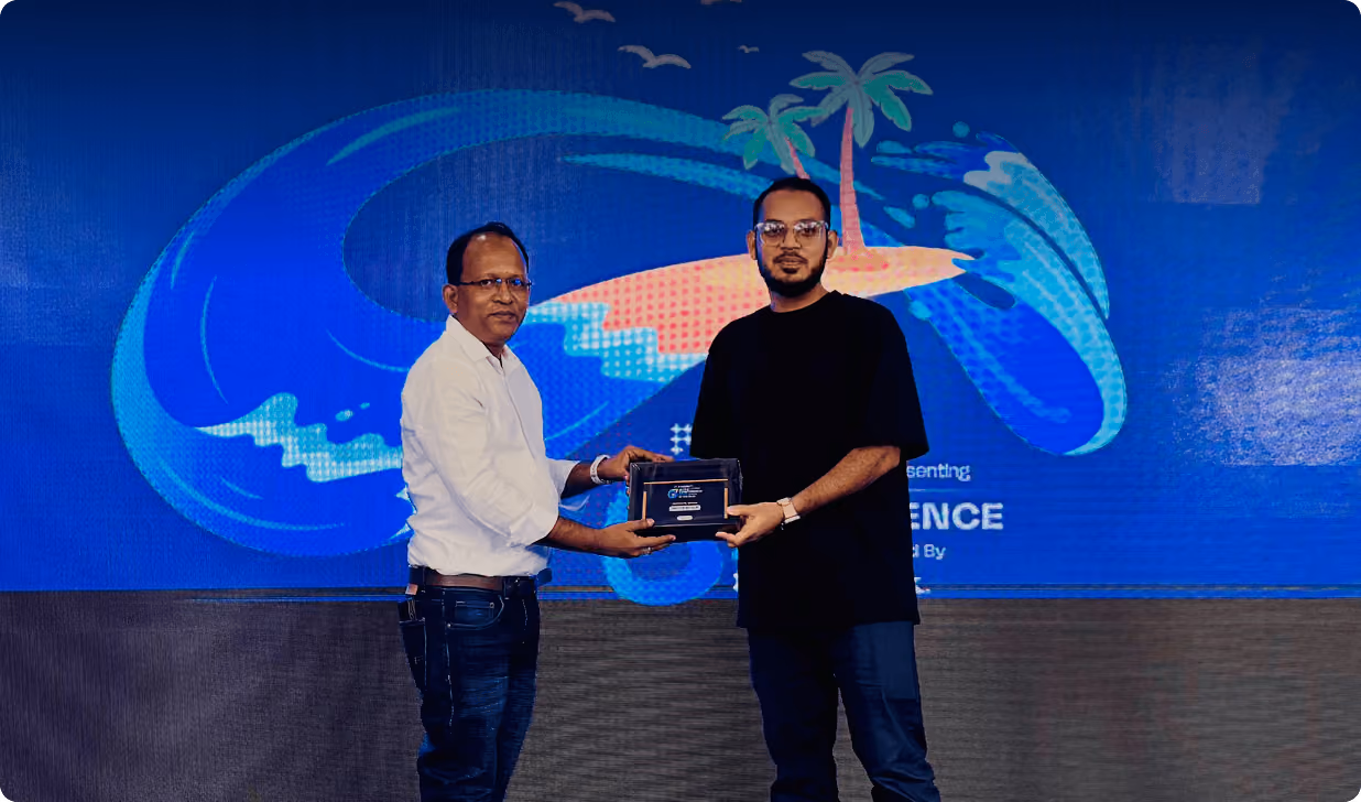 Shahid Miah, founder of Wavespace, receiving an award on stage at a tech summit