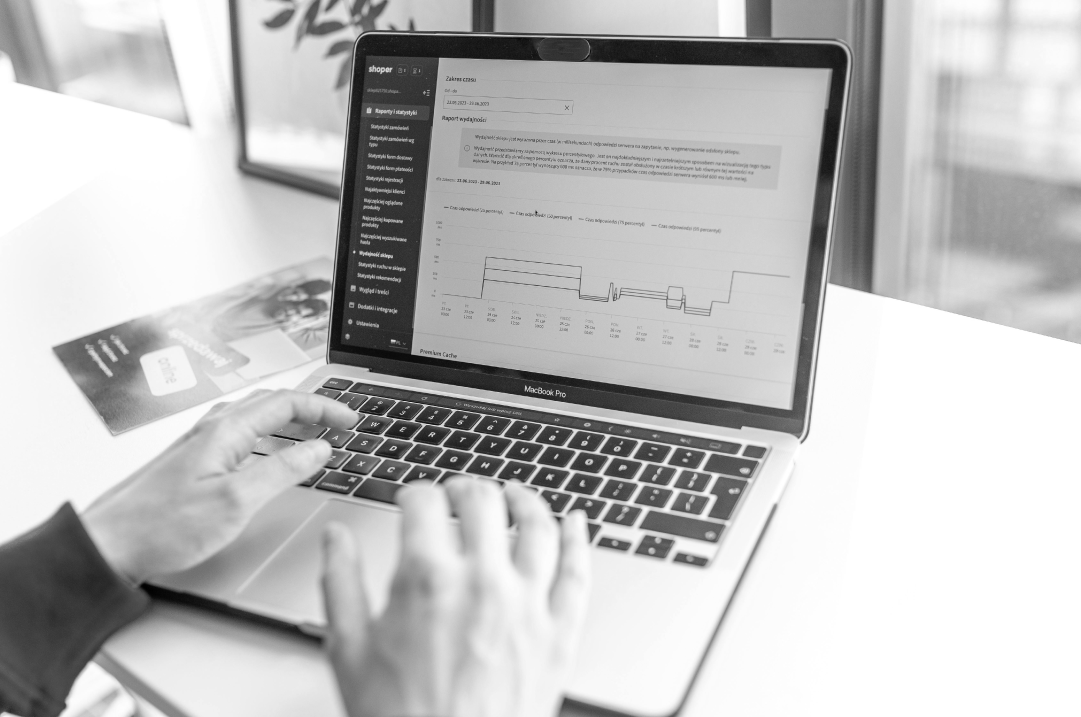 Hands are shown typing on a laptop.