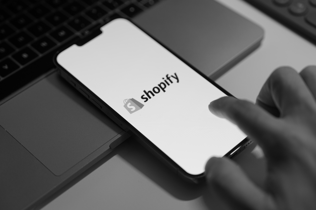 A mobile screen displays the Shopify mobile app.