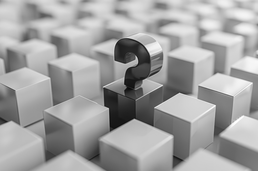 A scuptural question mark is in the middle of rows of blocks.