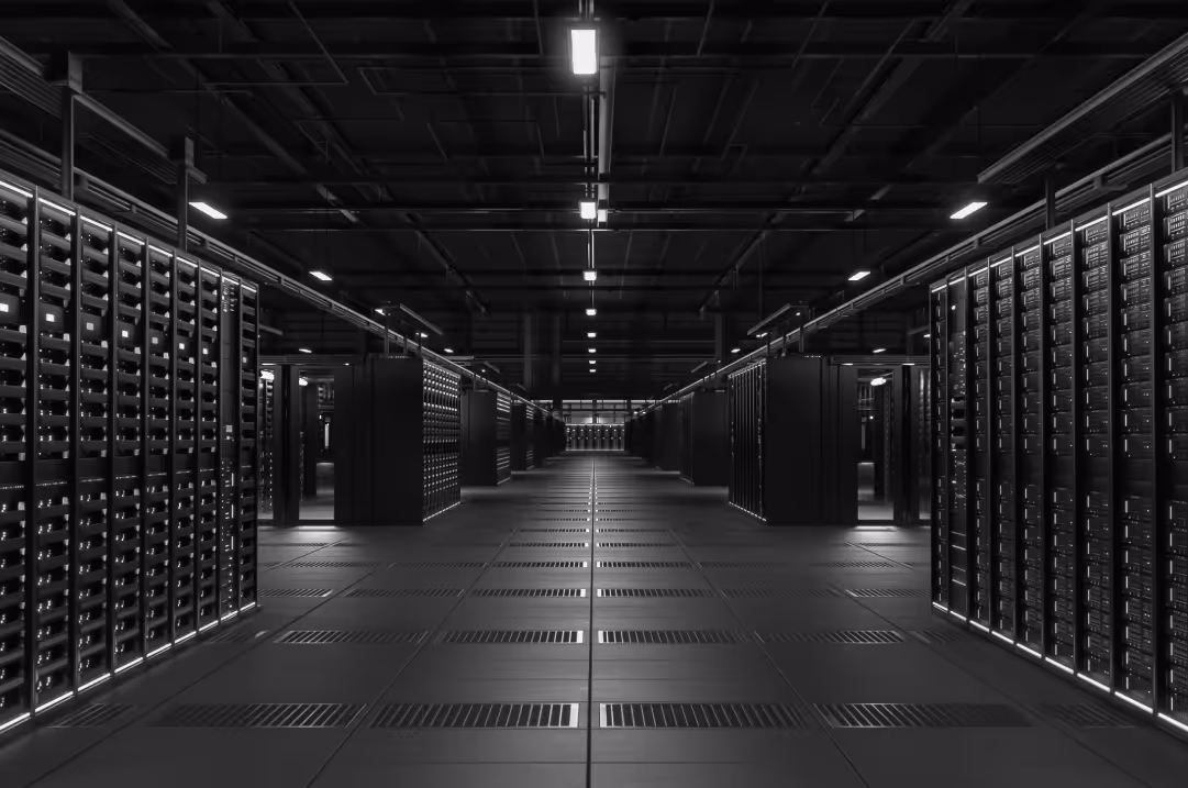 Two rows of servers line either side of a long room.