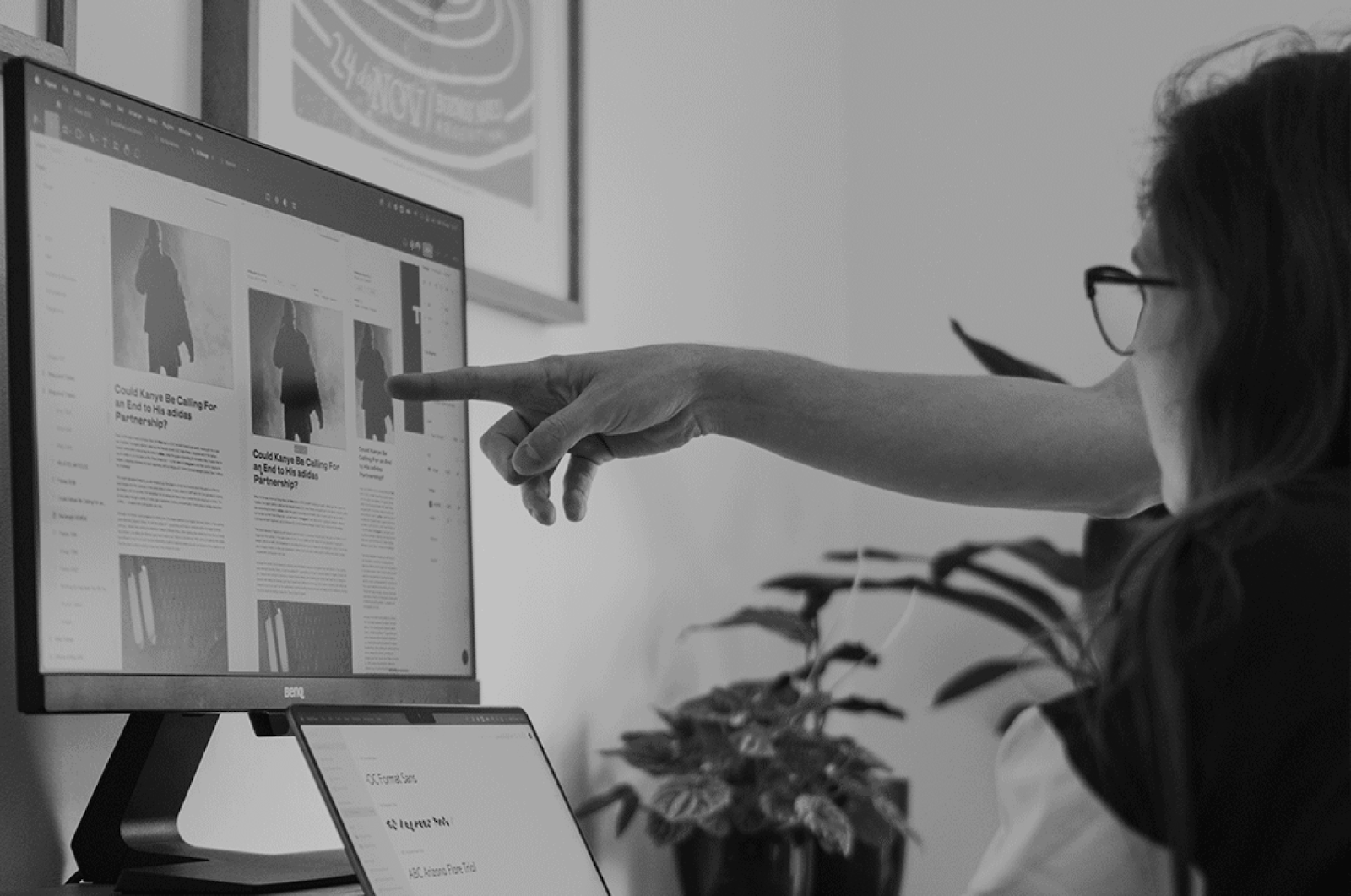 A woman is looking at different viewports of a webpage while someone else points to the screen.