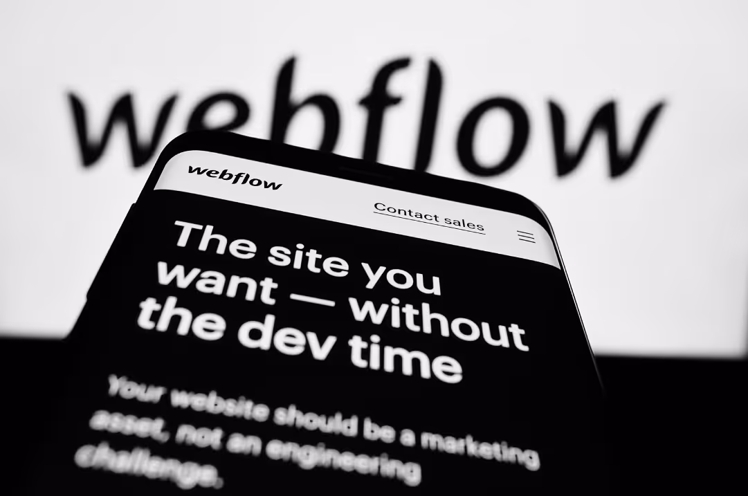 A mobile phone displays the webflow website in front of the webflow logo.