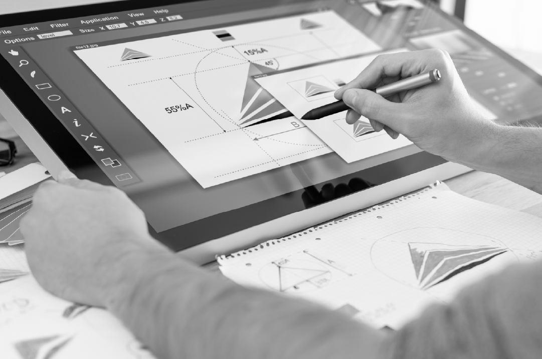 A person uses a stylus to move objects on the screen of a tablet.