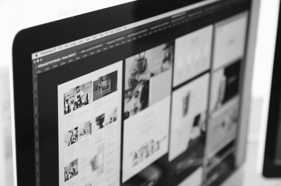 Website layout and design wireframes on a computer screen showing the connection between web design and development.