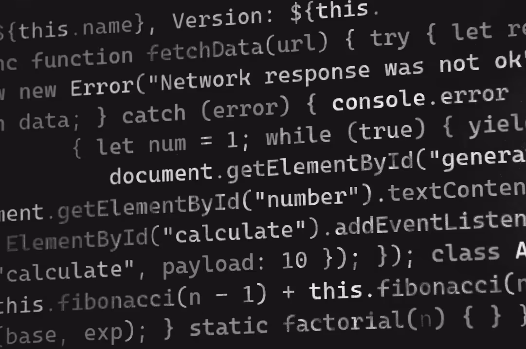 Lines of code are displayed on a screen.